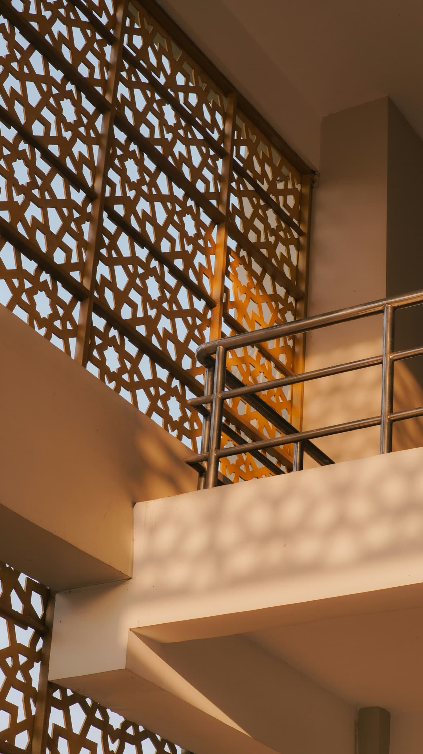 A Modern Arabic perforated screen filtering warm afternoon light